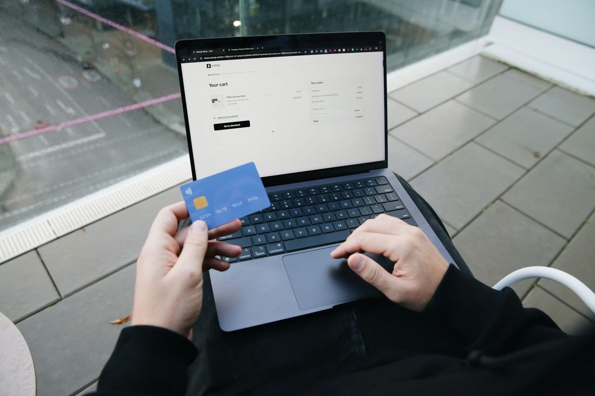 Person med bærbar PC og betalingskort som handler på nett